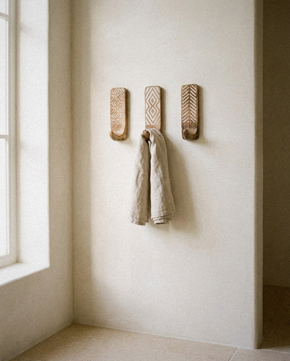 Carved Wooden Wall Hooks – Set of 3 styled in a minimal, sunlit room