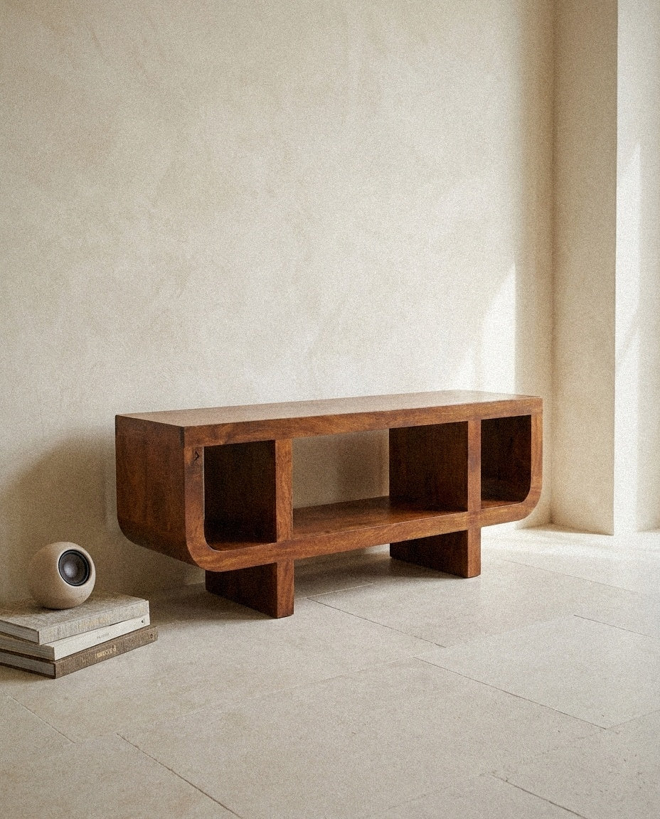Curved Mango Wood Media Console in a light organic modern interior