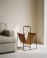 Faronworth - Magazine Rack - Brown / Black in a light organic modern interior