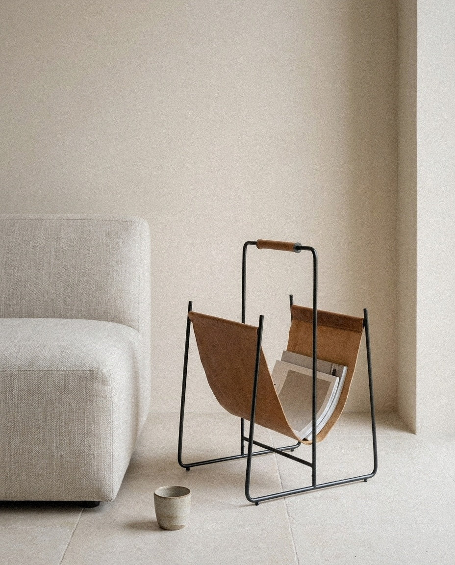 Faronworth - Magazine Rack - Brown / Black styled in a minimal, sunlit room