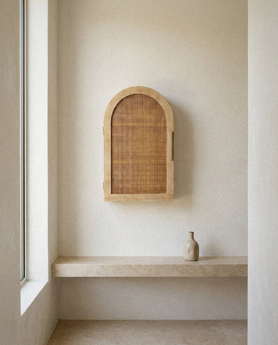 Ori Rattan Arch Wall Cabinet styled in a minimal, sunlit room