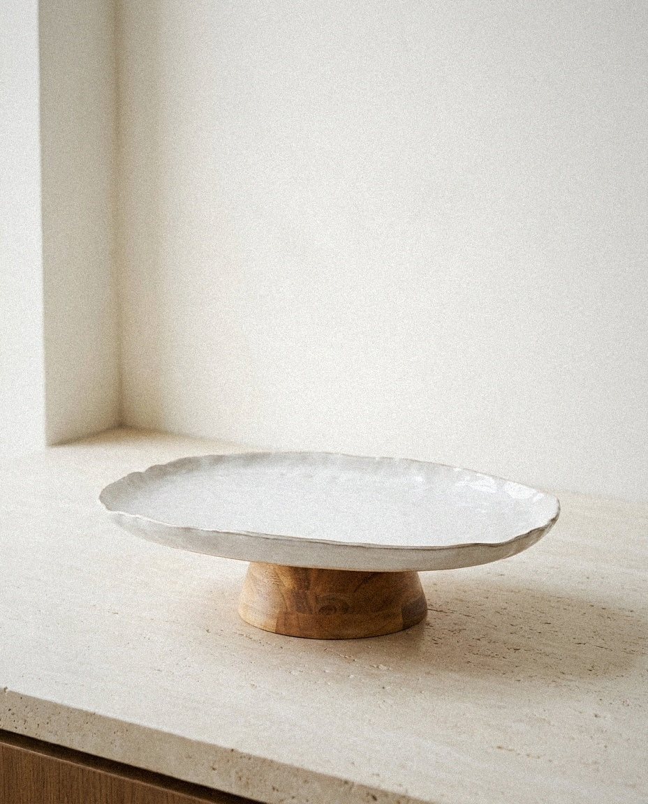 Stoneware Pedestal Dish with Acacia Base in a light organic modern interior