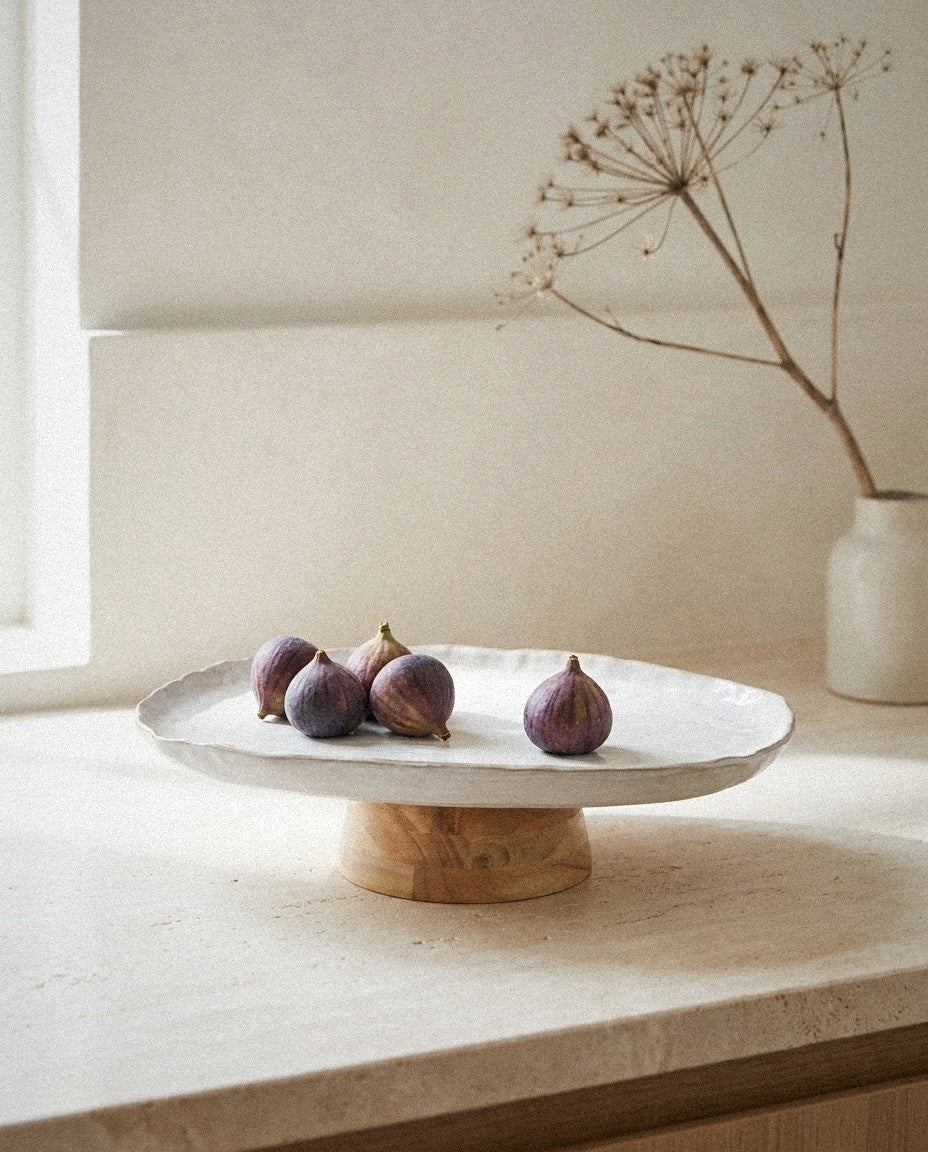 Stoneware Pedestal Dish with Acacia Base styled in a minimal, sunlit room