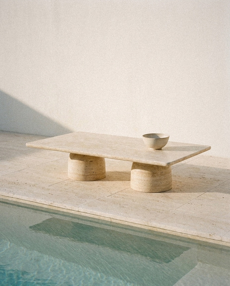 Travertine Sculptural Coffee Table styled in a minimal, sunlit room