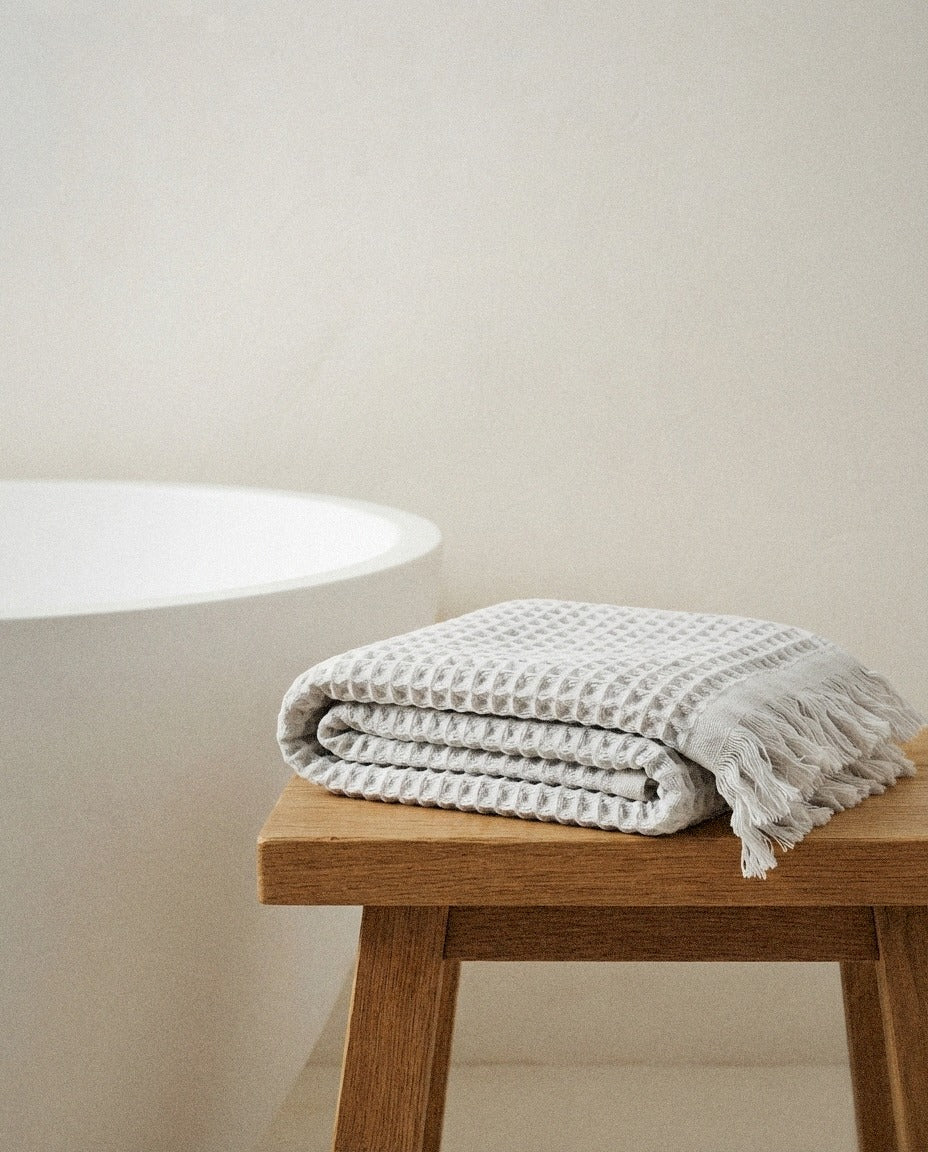 Waffle Hand Towel detail in a warm minimalist bathroom