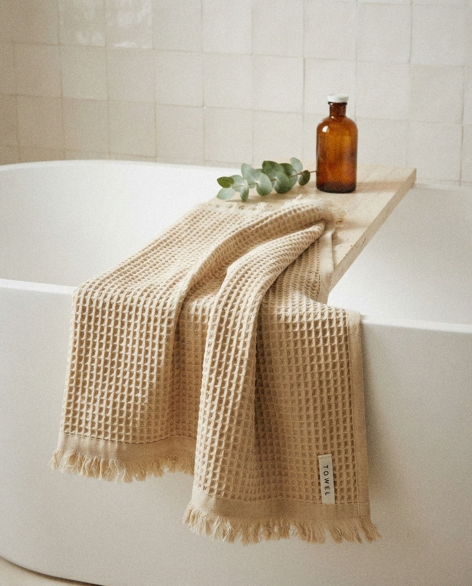 Turkish Waffle Bath Towel – Sand detail in a warm minimalist bathroom