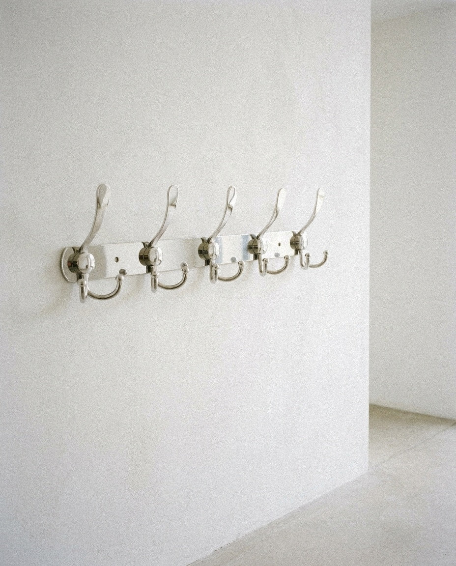 Wall Mount Coat 15 Hooks Stainless Steel Clothes Hanger Rack in a light organic modern interior
