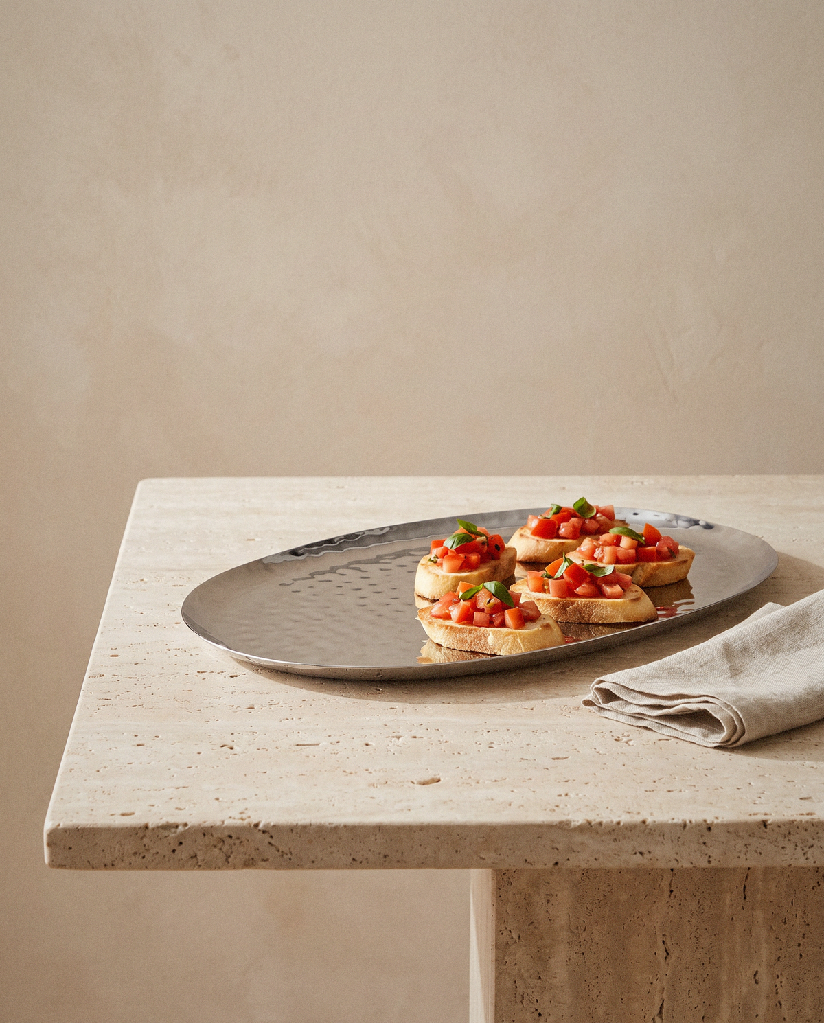 Polished Steel Oval Serving Tray styled in a calm minimalist living space