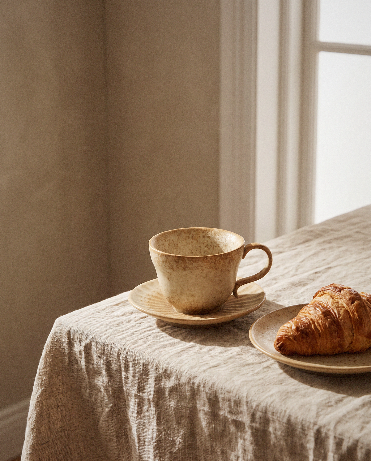 Speckled Cream Tea Cup Set styled in a calm minimalist living space